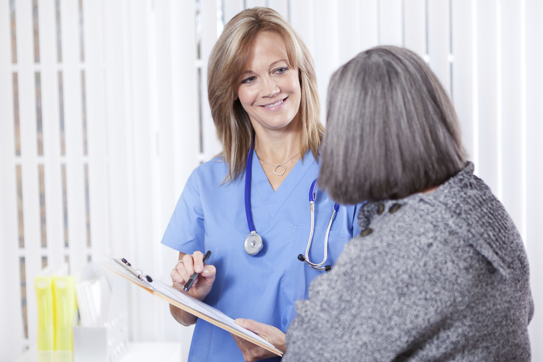 Image of a smiling doctor talking to a patient