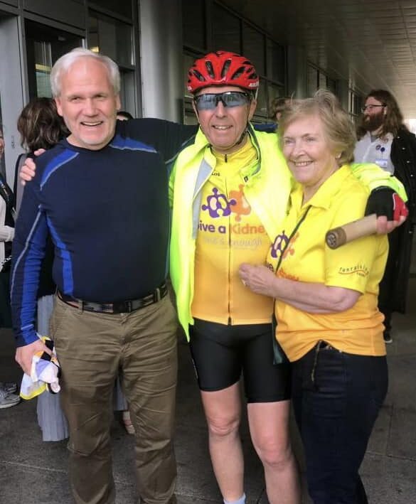Image of living kidney donor Dennis with two other living kidney donors, all in cycling clothing, smiling at the camera